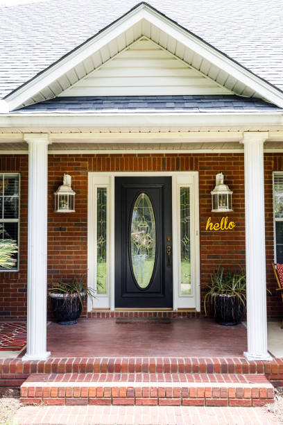 istock Black Front door of Traditional red brick home 1162774862