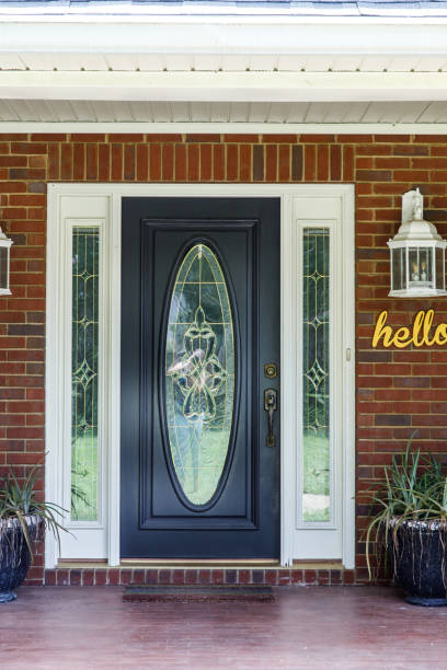 istock Black Front door of Traditional red brick home 1162774909