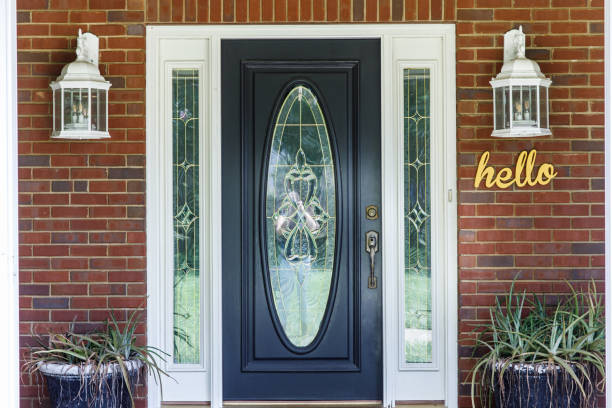 istock Black Front door of Traditional red brick home 1162774978