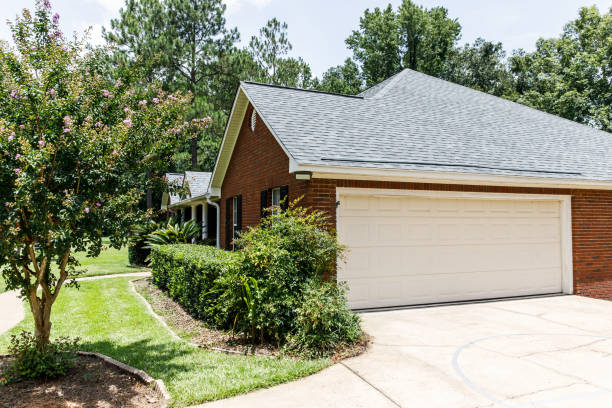 istock Red brick house cream colored garage 1162775506