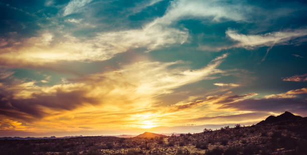 A sunset over the Sonoran Desert of Arizona with high altitude clouds panorama.