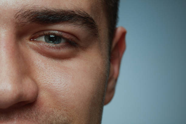 istock Close-up portrait of young man isolated on grey studio background 1162777593