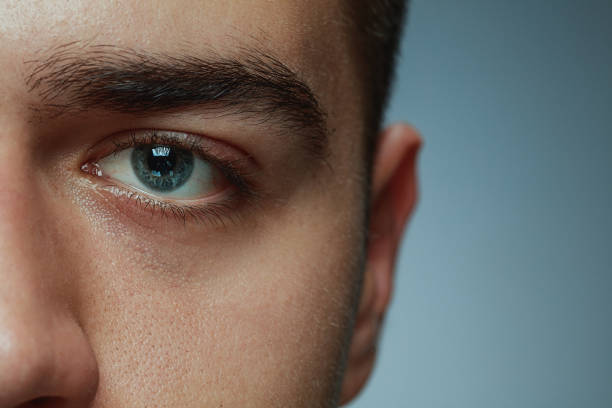 istock Close-up portrait of young man isolated on grey studio background 1162777594