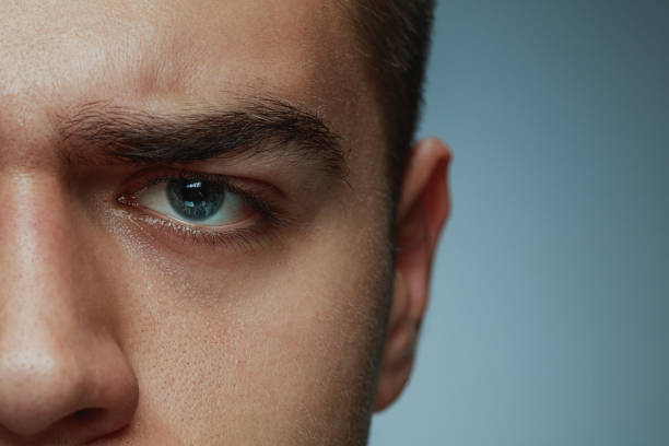 istock Close-up portrait of young man isolated on grey studio background 1162777612