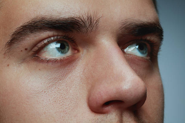 istock Close-up portrait of young man isolated on grey studio background 1162777614