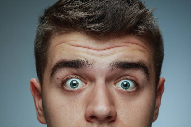 istock Close-up portrait of young man isolated on grey studio background 1162777618