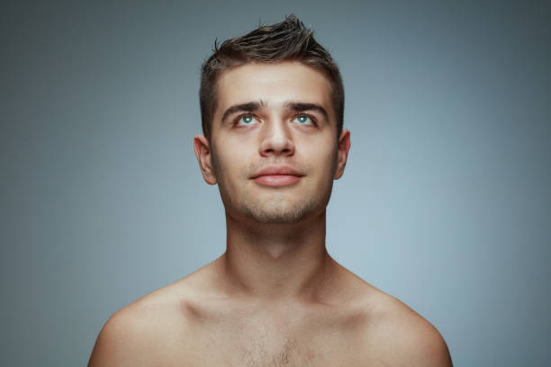 istock Portrait of shirtless young man isolated on grey studio background 1162777676