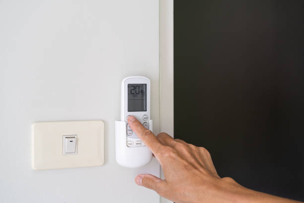 istock Man hand turn on air condition remote switch 1162777775