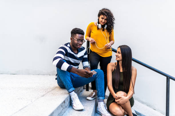 istock Group of smiling millennials using mobile phone 1162778719