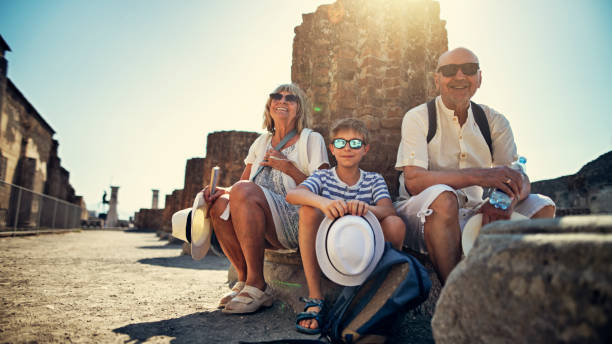 istock Senior couple with grandson sightseeing ancient ruins 1162780276