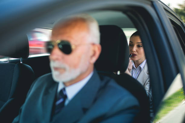 istock Beautiful business woman is working in car 1162780721