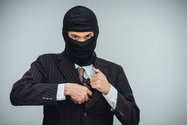 mafioso in suit pulls out a gun before the bank robbery work - gun men spy suit imagens e fotografias de stock