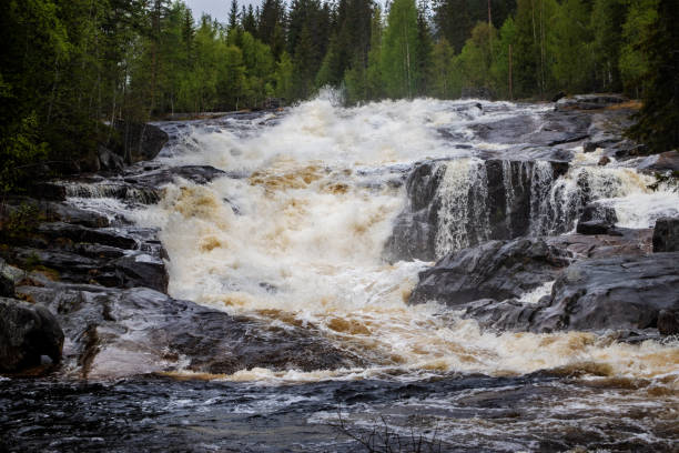 istock River with small waterfalls and a cloudy sky close up 1162785429