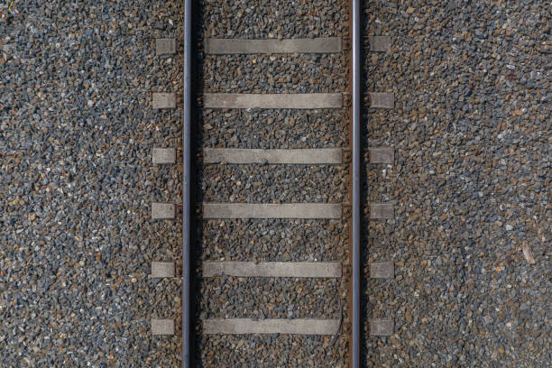 railway rails with sleepers on gravel close-up top view - railroad spikes imagens e fotografias de stock