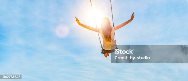 Woman On A Swing With Blue Sky Stock Photo - Download Image Now - Women, Freedom, Happiness