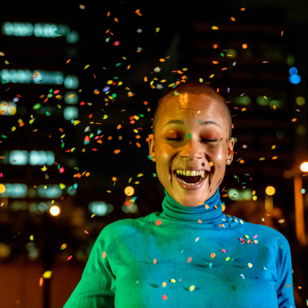 istock Cool woman under a rain of confetti 1162789734