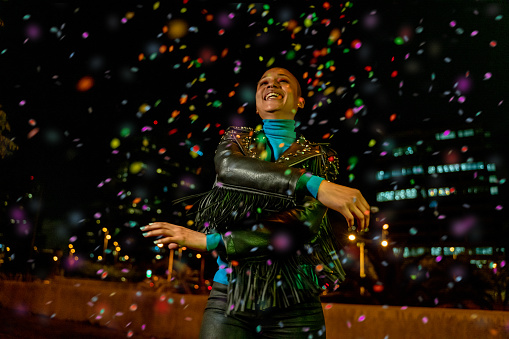 Cool woman under a rain of confetti