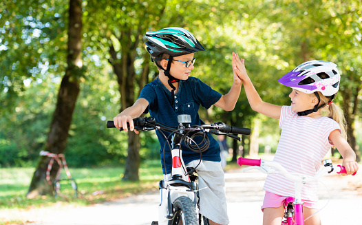 A multiracial family biking on a large electric powered cargo bicycle, perfect for commuting for the environmentally conscious.  Also a fun, healthy family activity that provides good exercise!  Shot in Tacoma, Washington, USA.