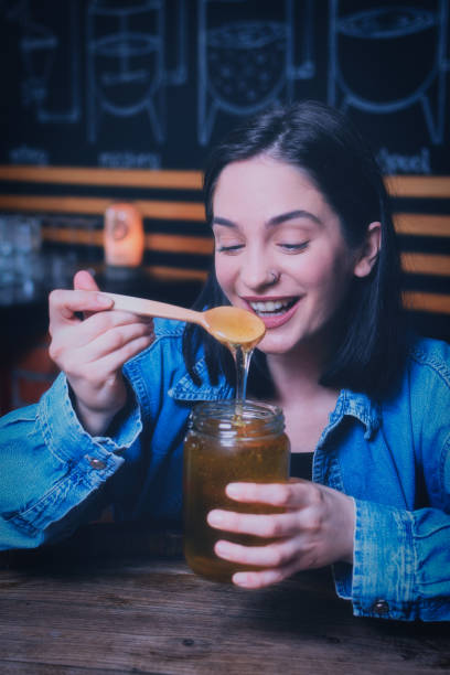 istock Girl eating honey 1162791792