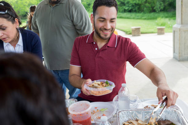 istock Young man makes a plate during family picnic 1162792016