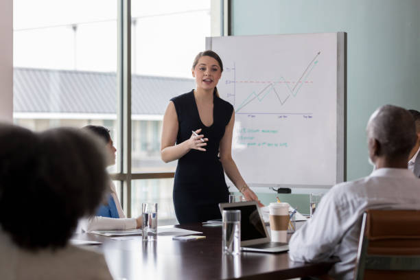 istock At meeting, mid adult employee explains projected numbers 1162792722