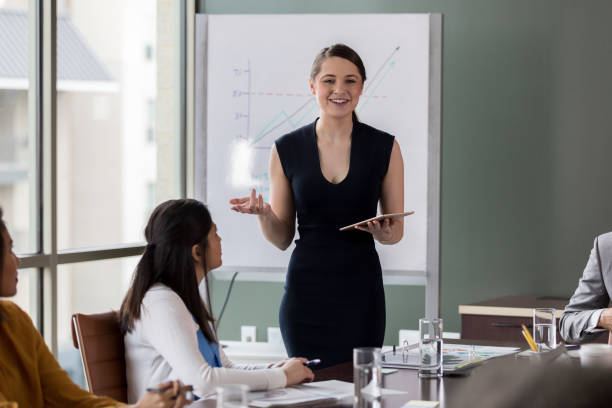istock Using digital tablet, business woman explains expenses 1162792725