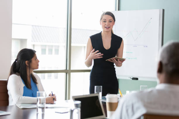 istock Using digital tablet, mid adult woman explains business trends. 1162792751