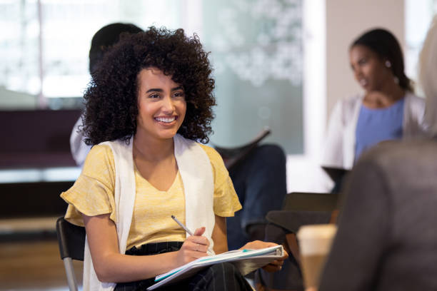 istock Cheerful therapist facilitates group therapy session 1162792847