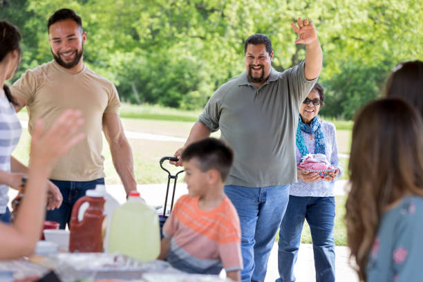 istock Man waves while arriving at family reunion 1162792870