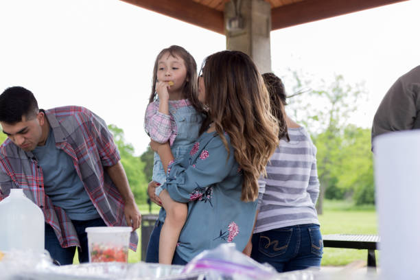istock Aunt gives niece a cookie before picnic lunch 1162792916