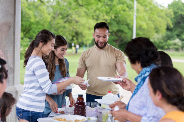 istock Large, multi-generational family enjoys eating together at park 1162792950