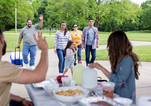 The rest of the family arrives and waves The rest of the large extended family waves as they arrive at the pavilion for the picnic. pavilion stock pictures, royalty-free photos & images