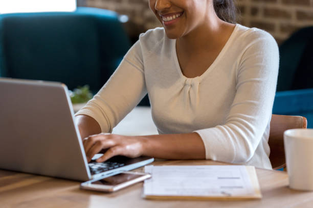 istock Cheerful woman telecommutes from coffee shop 1162793077