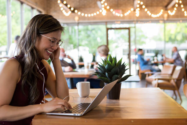 istock Smiling woman uses laptop 1162793875