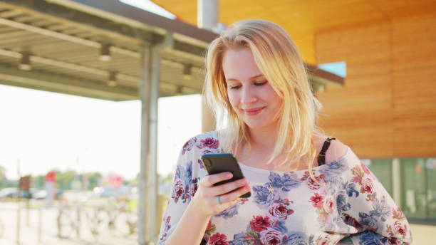 istock Lady Using a Phone Outdoors 1162794962