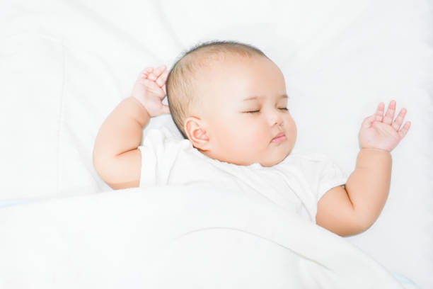istock Sleeping Asian baby girl in white background 1162796449