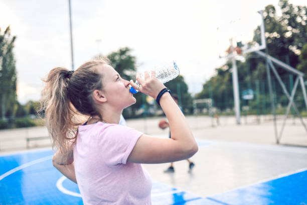 istock Female Drinking Water During Basketball Training 1162796681