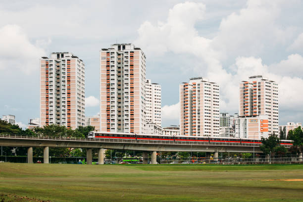 Singapore mrt railway train pass though residential area view Singapore-01 DEC 2018: Singapore mrt railway train pass though residential area singapore mrt stock pictures, royalty-free photos & images
