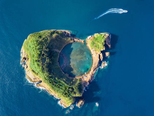 Photo of Azores aerial panoramic view. Top view of Islet of Vila Franca do Campo. Crater of an old underwater volcano. San Miguel island, Azores, Portugal. Heart carved by nature. Bird eye view.