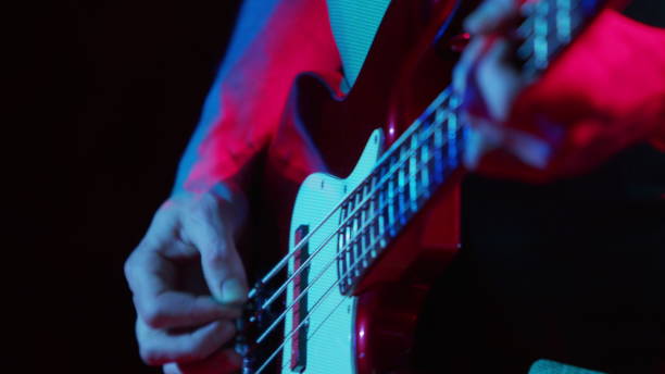 Guitarist paying at the concert. Closeup shot