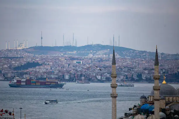Photo of Large cargo container ship passing through Bosphorus, Istanbul, panorama of bosphorus