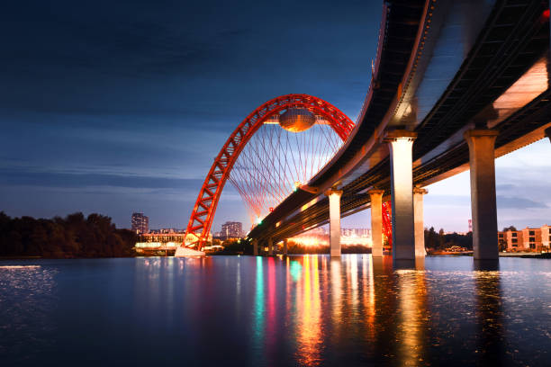 istock Evening dawn behind monumental cable-stayed bridge above Moskva river in Moscow 1162804080