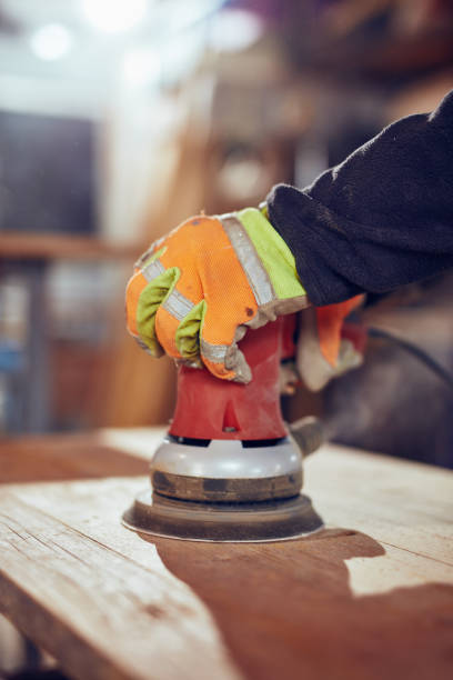 istock Carpenter using orbital electric sander in a retro vintage works 1162805037