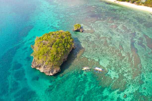 istock Small rocky island in the blue lagoon, view from above 1162805282