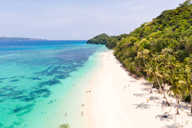 istock Puka Shell Beach. Wide tropical beach with white sand. Beautiful white beach and azure water on Boracay island, Philippines, top view 1162805976