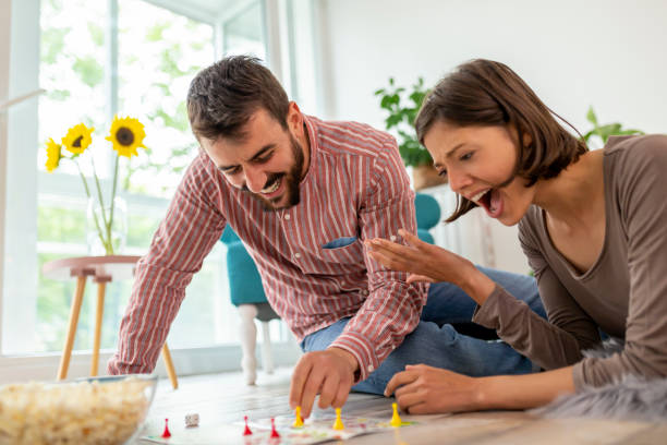 istock Couple playing board games at home 1162809378