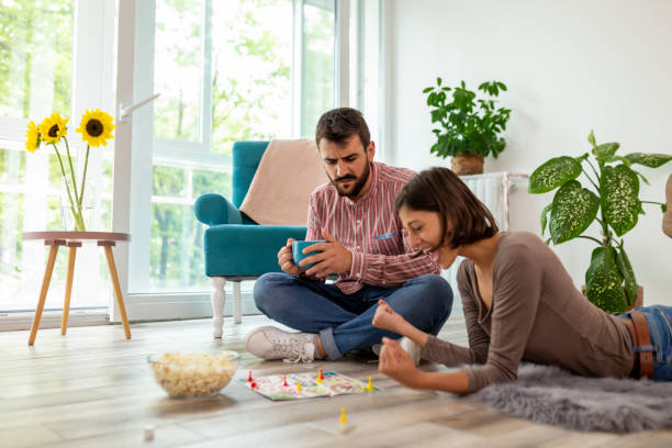 istock Couple playing ludo board game 1162809584