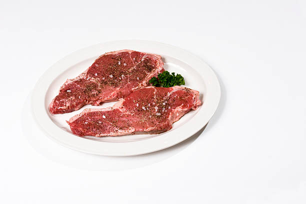istock two raw New York strip steak on a white background 116281040