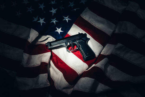 istock Gun Laying on an American Flag in Gun Control Concept 1162810646