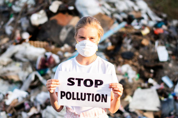 istock Woman Activist With Stop Polution On Waste Dump. Recycle, Eco, Reuse Concept. 1162814004